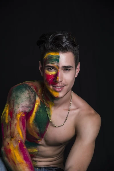 Attractive young man shirtless, skin painted all over with colors — Stock Photo, Image
