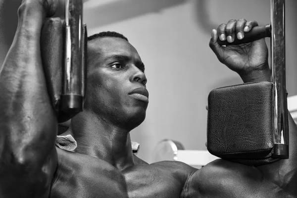 Hunky muscular black bodybuilder working out in gym — Stock Photo, Image