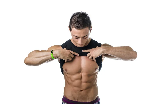 Handsome, fit young man pulling up t-shirt revealing abs — Stock Photo, Image