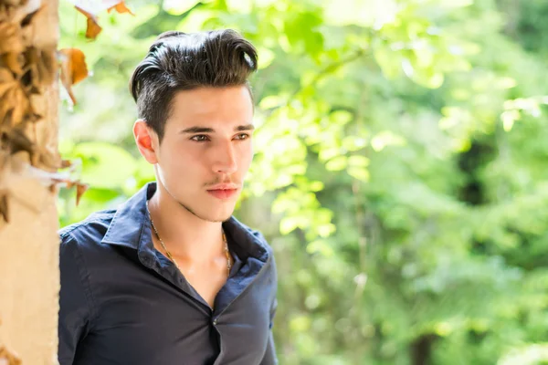 Serious looking  young man looking outside — Stock Photo, Image