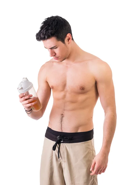 Attractive young man holding protein shake bottle — Stock Photo, Image