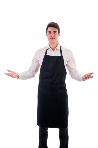 Νεαρός σεφ ή φορούν μαύρη ποδιά σερβιτόρου — Φωτογραφία Αρχείου