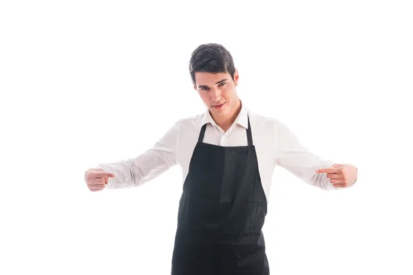 Jovem chef ou garçom vestindo avental preto isolado — Fotografia de Stock