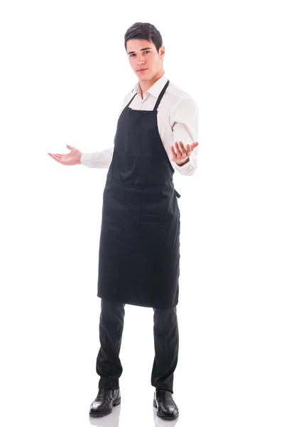 Young chef or waiter wearing black apron isolated — Stock Photo, Image