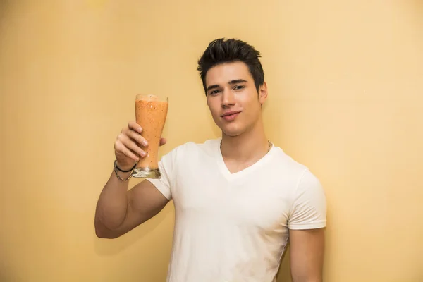 Young man saluting with a healthy drink — kuvapankkivalokuva