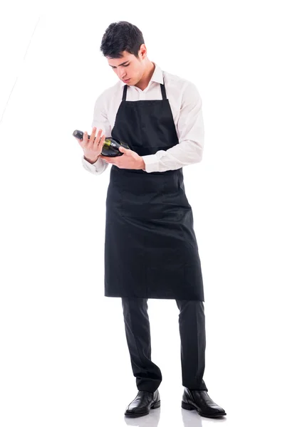 Attractive young chef holding green champagne bottle — Stock Photo, Image