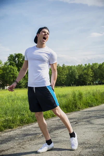 Schöner junger Mann verletzt beim laufen und Joggen auf der Straße — Stockfoto