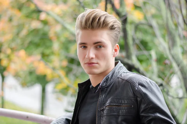 Attractive blond young man in city park — Stock Photo, Image