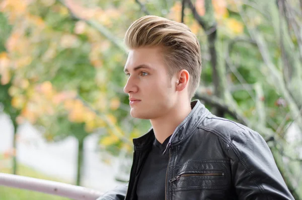 Attractive blond young man in city park — Stock Photo, Image