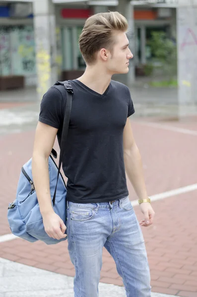 Attractive young man with backpack standing outside — Stock Photo, Image