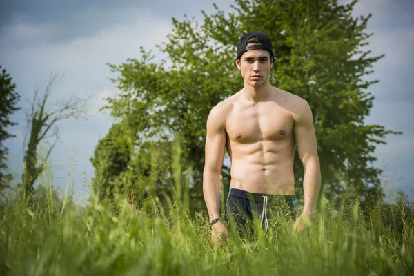 Handsome shirtless fit young man at countryside — Stock Photo, Image