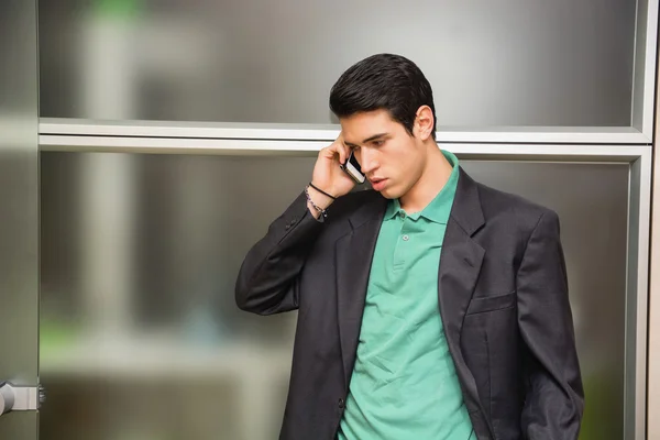 Handsome young businessman talking on cell phone — Stock Photo, Image