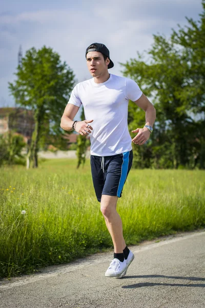 Young man running and jogging — Stock Photo, Image