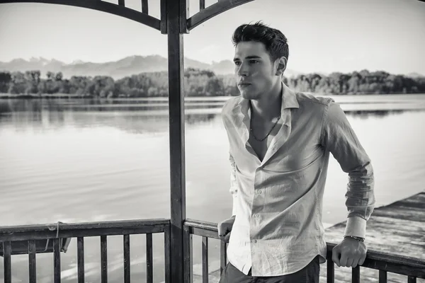 Young man on a lake in a sunny, peaceful day — Stock Photo, Image