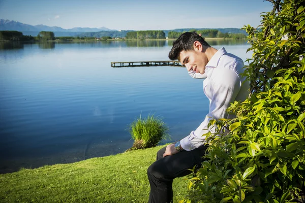 Young man on a lake in sunny — Stock Photo, Image