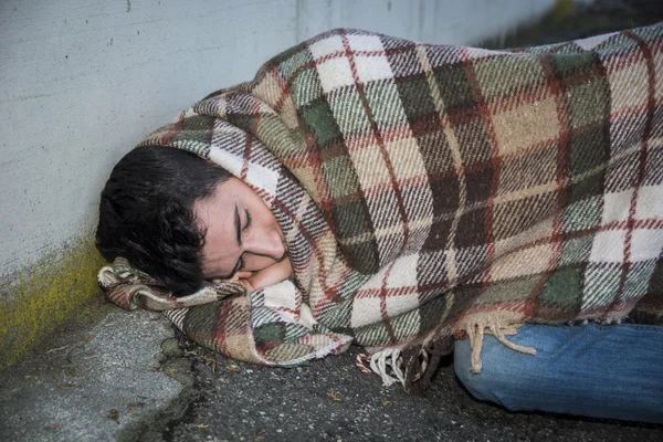 Male beggar on city sidewalk sleeping — Stock Photo, Image