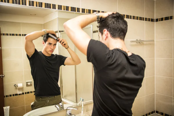 Reflection of Man Bushing Hair in Mirror — Stock Photo, Image