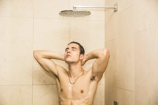 Atrakcyjny młody człowiek mięśni biorąc prysznic — Zdjęcie stockowe