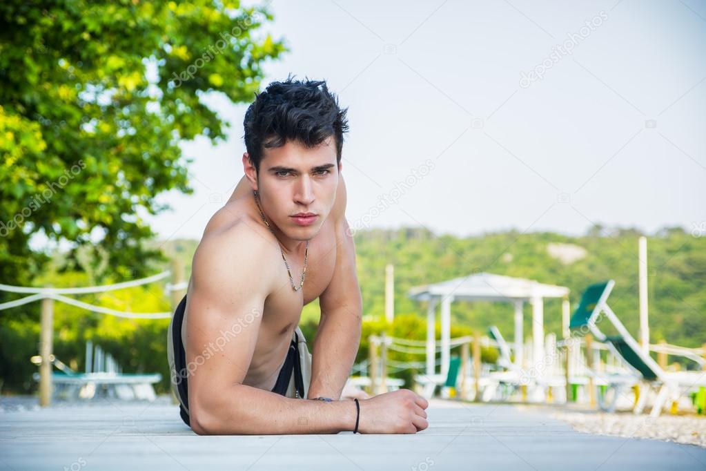 Young Man Lying on Stomach on Sun Deck