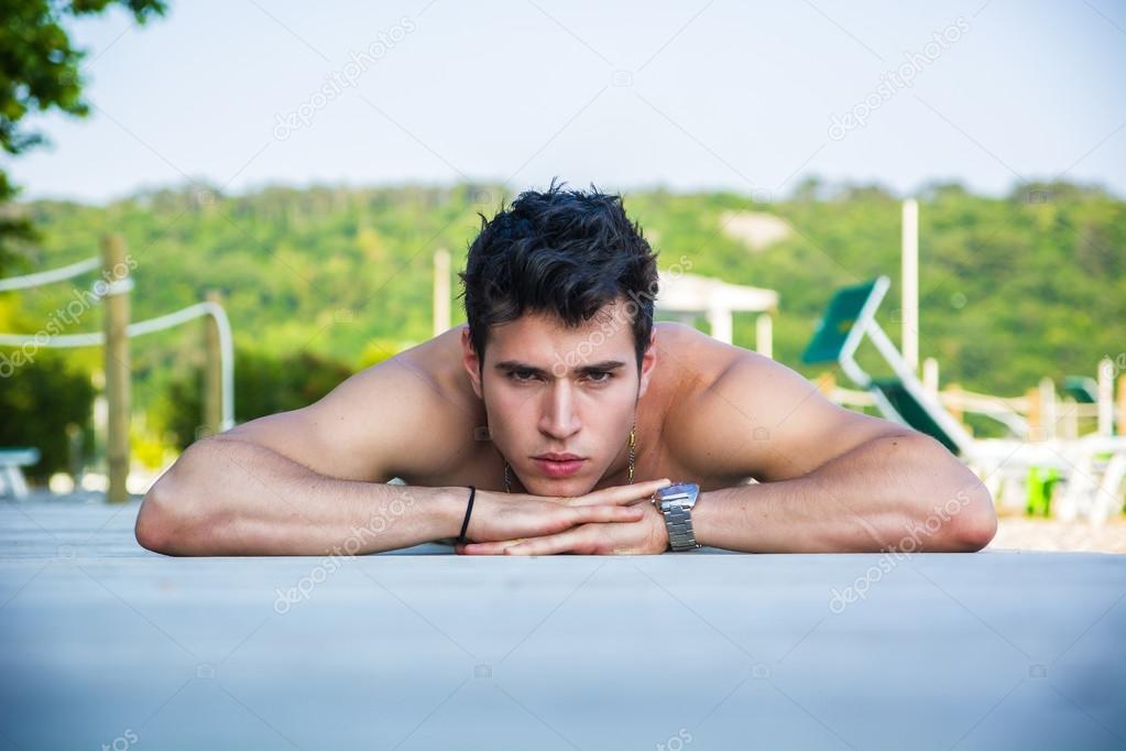 Young Man Lying on Stomach on Sun Deck