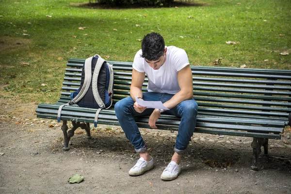 Young Male Student Studying at the Bench Seriously — Stock fotografie