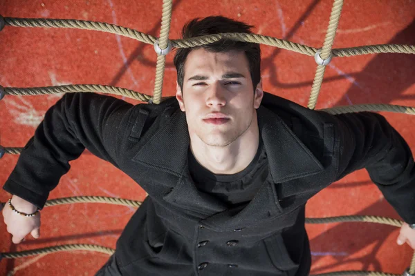 Full length of serious 20s man on climbling rope — Stock Photo, Image