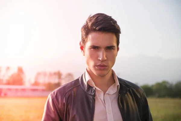 Handsome young man at countryside, in front of field or grassland — Stock Photo, Image