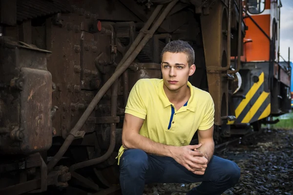 Handsome young man next to wood planks wall — 图库照片