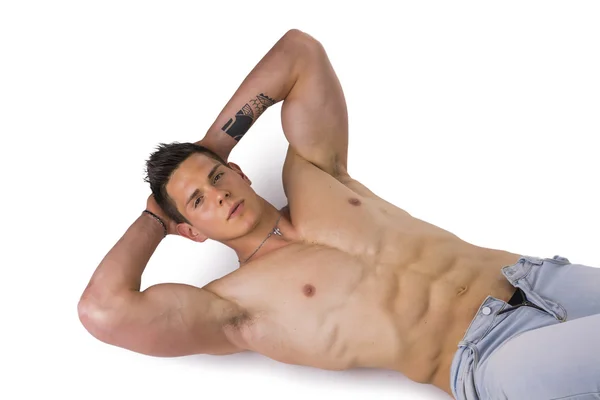 Handsome young bodybuilder laying down on the floor — Stock Photo, Image