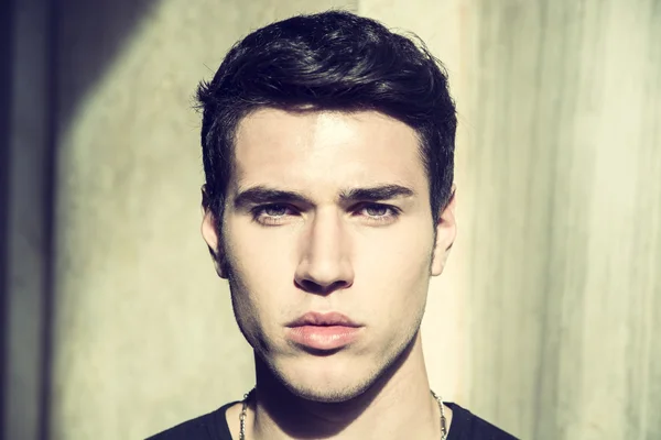 Handsome young mans headshot, indoor, lit by sunlight — Stock Photo, Image