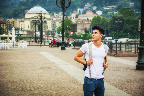 Handsome young man walking in European city square — 스톡 사진