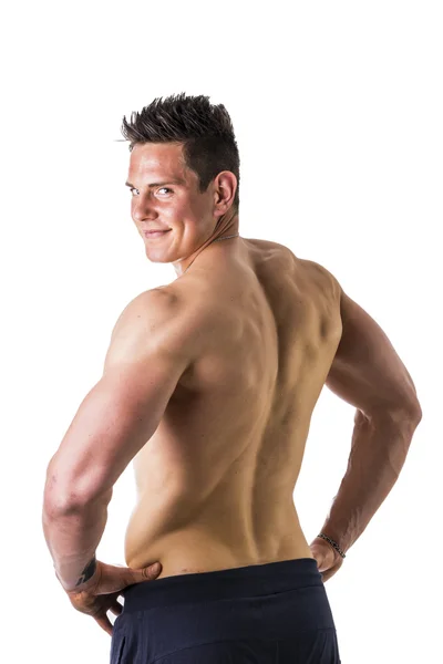 Back of topless muscular man standing, studio shot — Stock fotografie