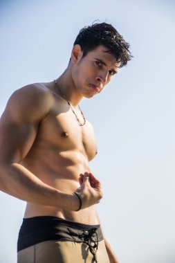 Muscular young man shirtless doing Italian gesture