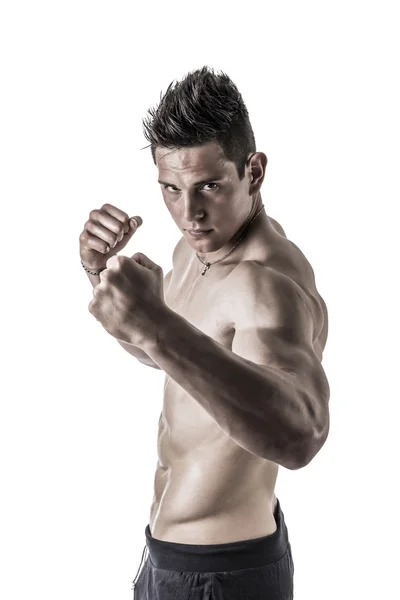 Shirtless male model throwing punch towards camera — Stock Photo, Image