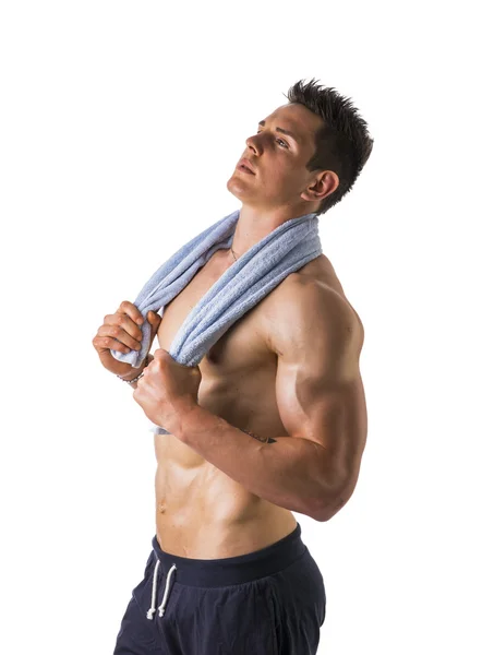 Handsome power athletic young man holding towel — Stock Photo, Image