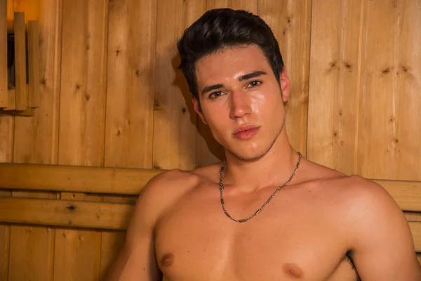 Young Man Relaxing in Sauna, Sitting on Wood Bench — Fotografia de Stock