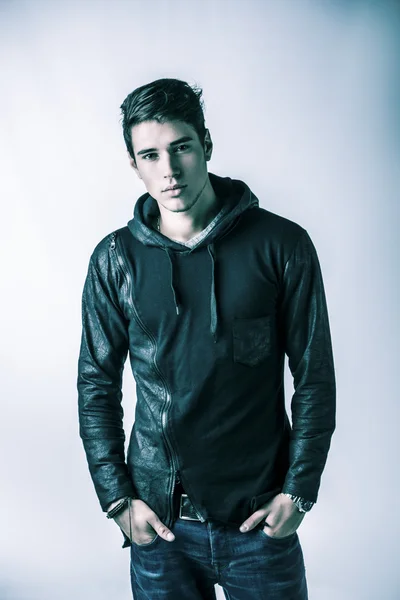 Handsome young man in black hoodie sweater, studio shot — ストック写真