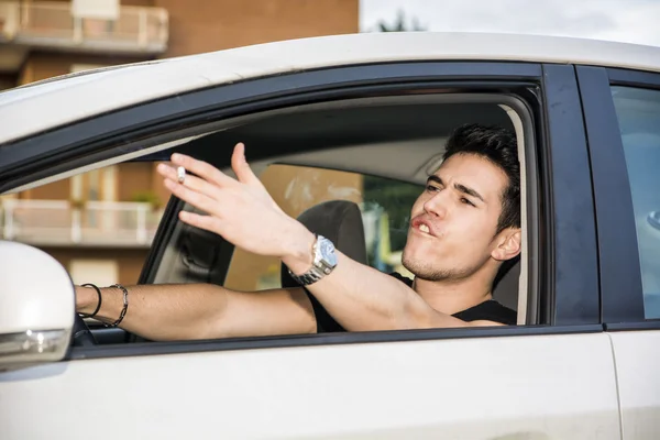 Angry Young Man Driving a Car and Yelling at Someone — ストック写真