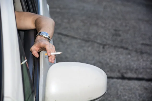 Young Man smoking cigarette while Driving — Stock Photo, Image