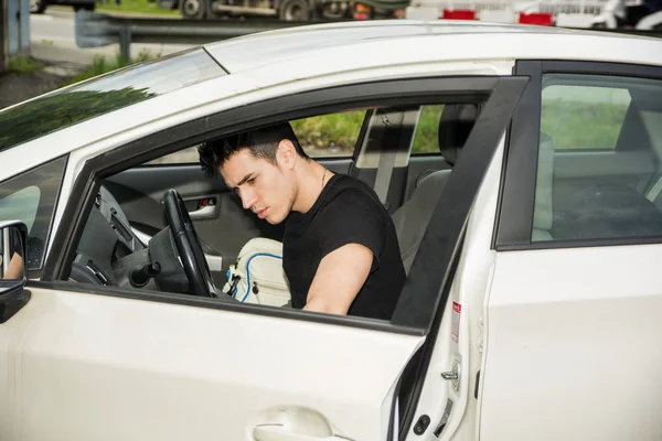 Young man getting out of white car — Foto Stock