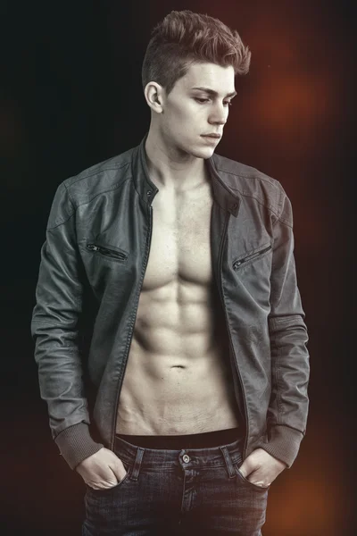 Handsome young man wearing leather jacket on naked torso — Stock Photo, Image