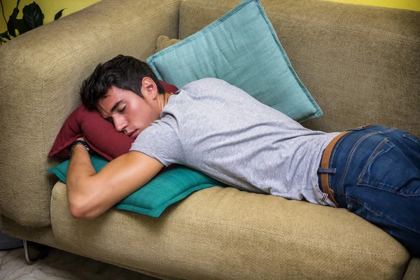 Пьяный молодой человек, спать на диване гостиной — стоковое фото