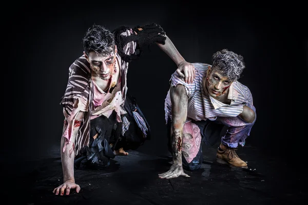 Twee mannelijke zombies kruipen op hun knieën, op zwarte rokerige achtergrond — Stockfoto