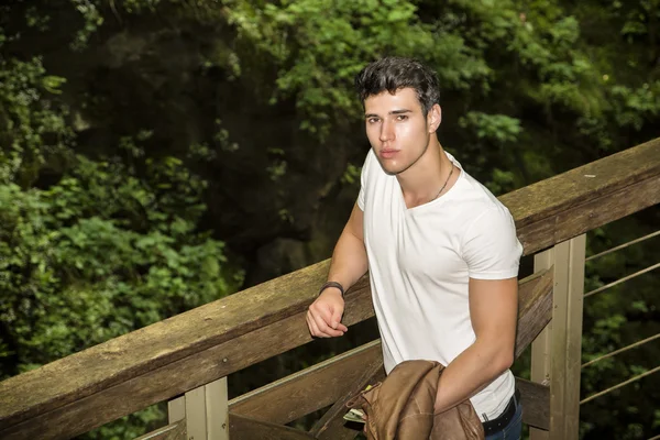 Handsome Young Man Leaning Against Pathway Rail — Stok fotoğraf