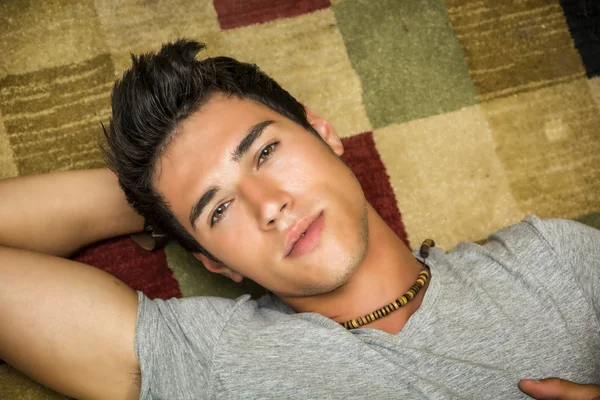 Cool handsome young man laying on the floor — Stock Photo, Image