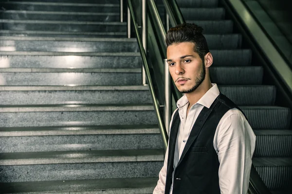 Profile shot of handsome young man inside train station — Stock Photo, Image