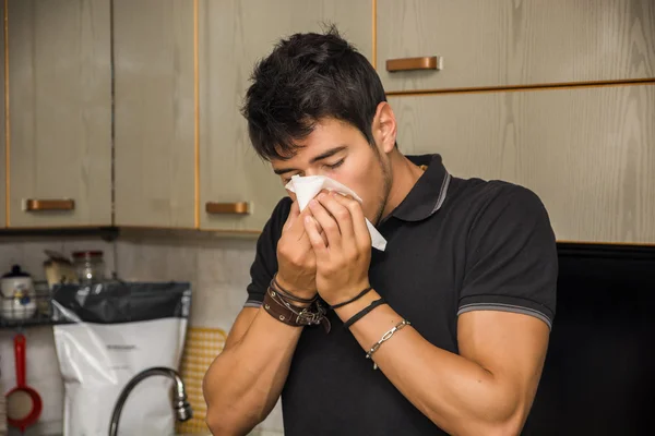 Young Man Blowing Nose into Tissue — Stock Photo, Image