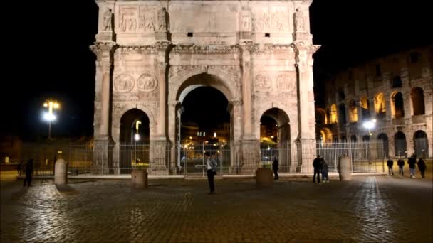 イタリア、ローマのコンスタンティヌスの前を夜歩いて若い男 — ストック動画