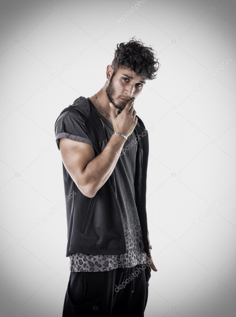 Tough young man in dark t-shirt isolated