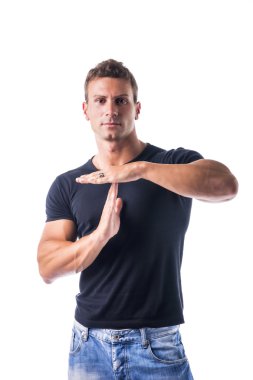 Young man gesturing time out sign with his hands